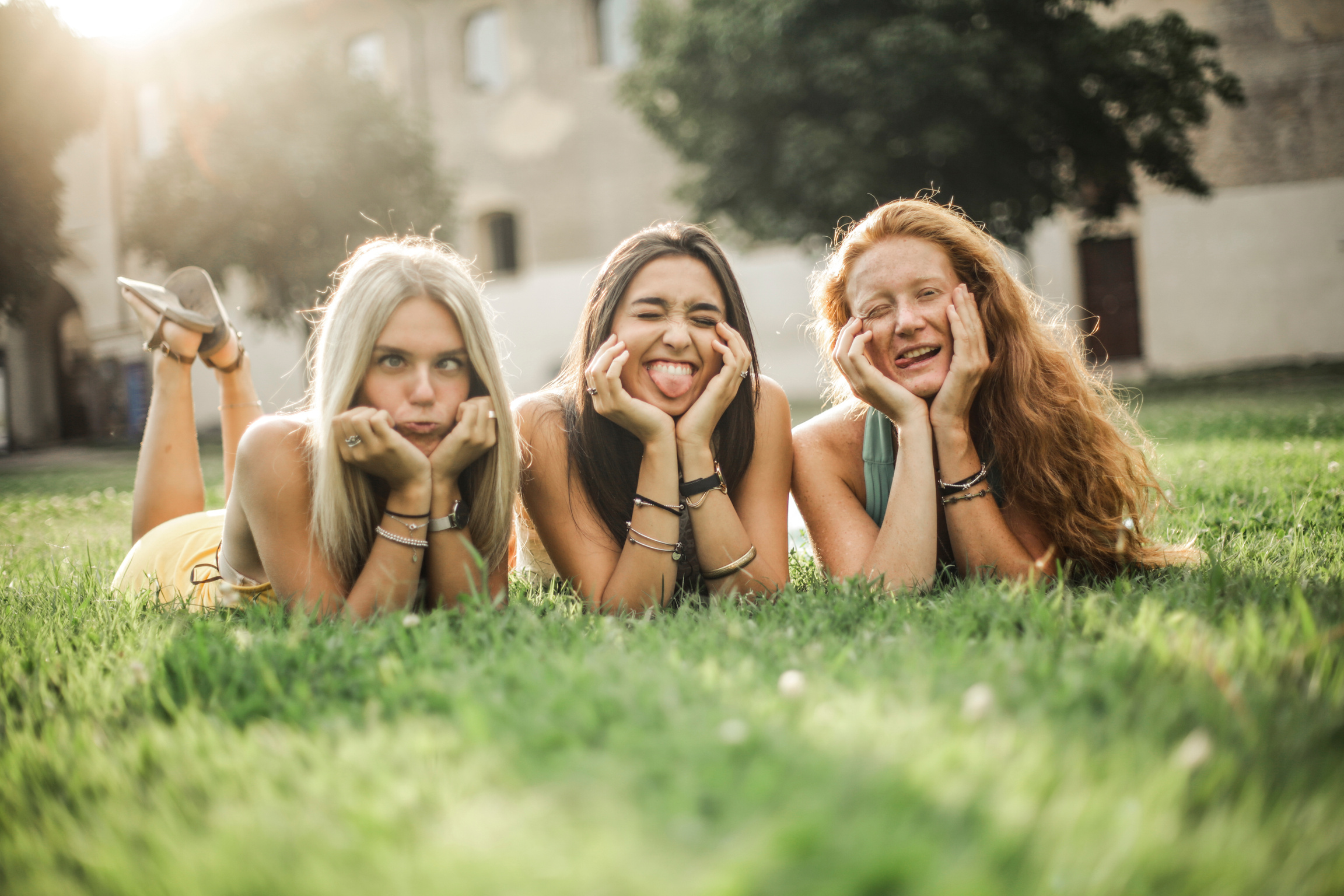 Happy female friends making funny faces